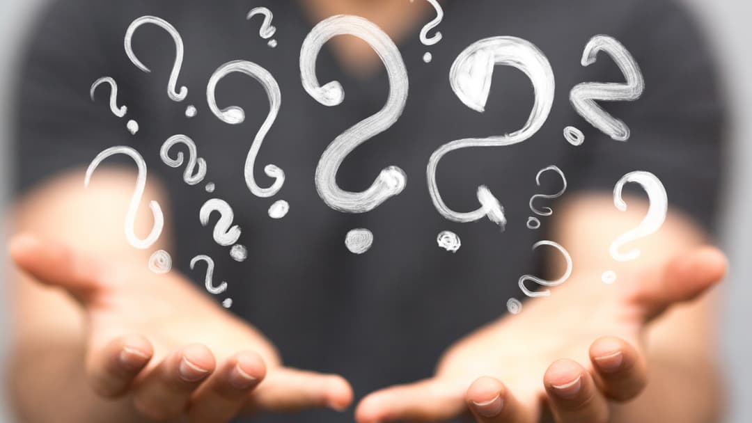 Open hands with question marks emerging, symbolizing the exploration of what it means to be queer