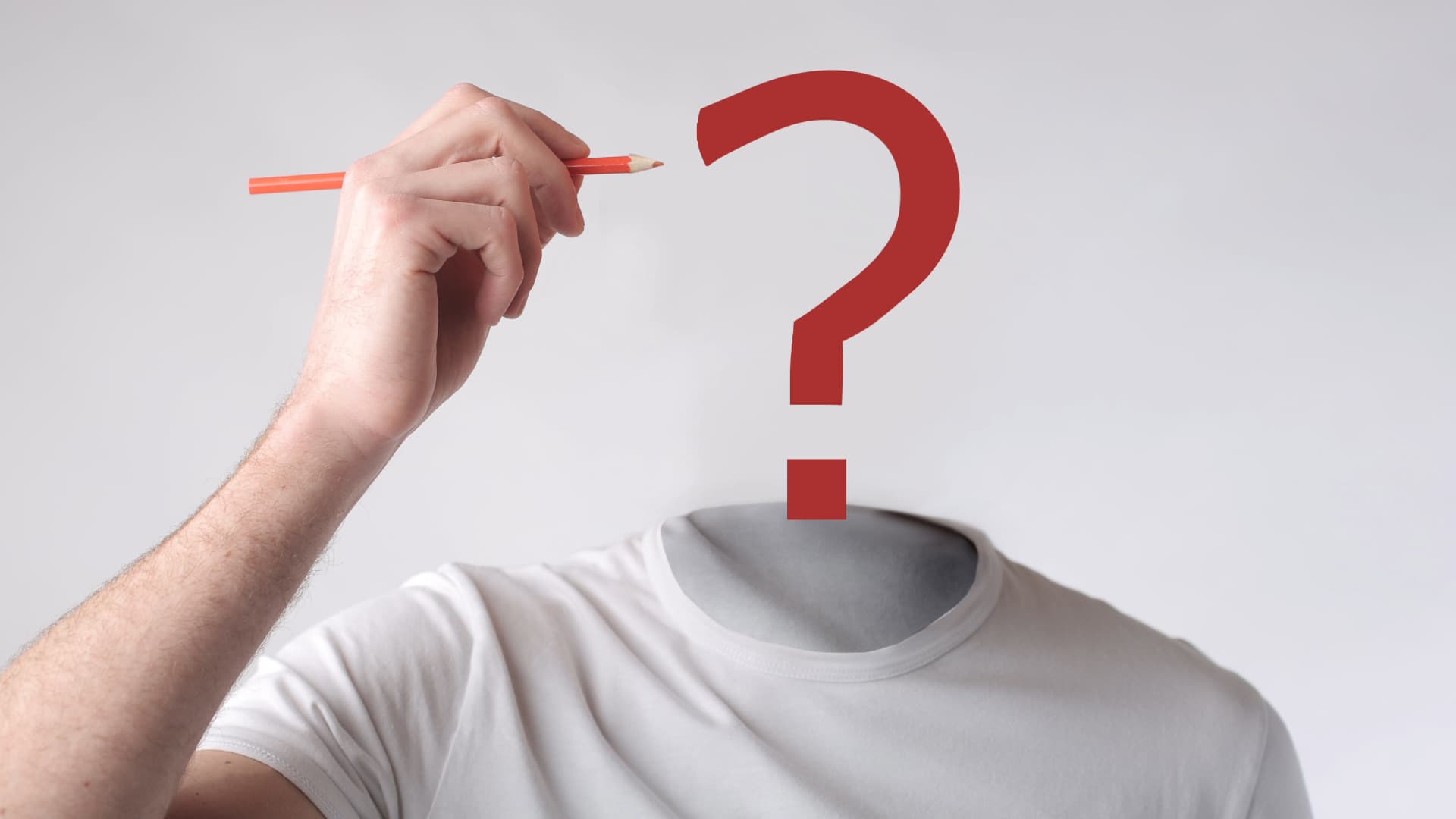 A person with a question mark for a head, drawing with a pencil, symbolizing the exploration of identity in art.