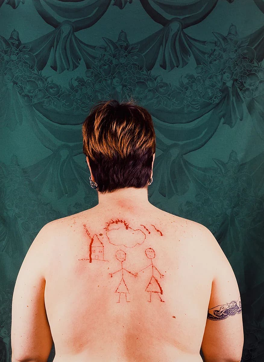 Catherine Opie capturing her iconic photographs of queer individuals, exploring themes of identity.