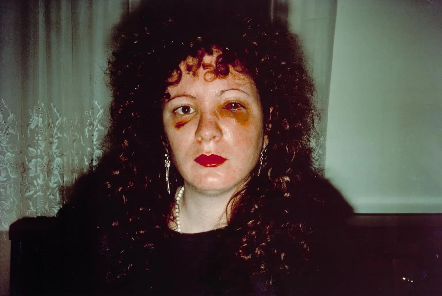 Nan Goldin capturing candid and intimate moments in her photography, bringing the LGBTQ+ experience into focus.